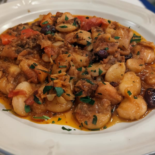 Close-up of Stella's Greek Cuisine's giouvetsi, a traditional Greek dish with pasta, meat, and tomato sauce.